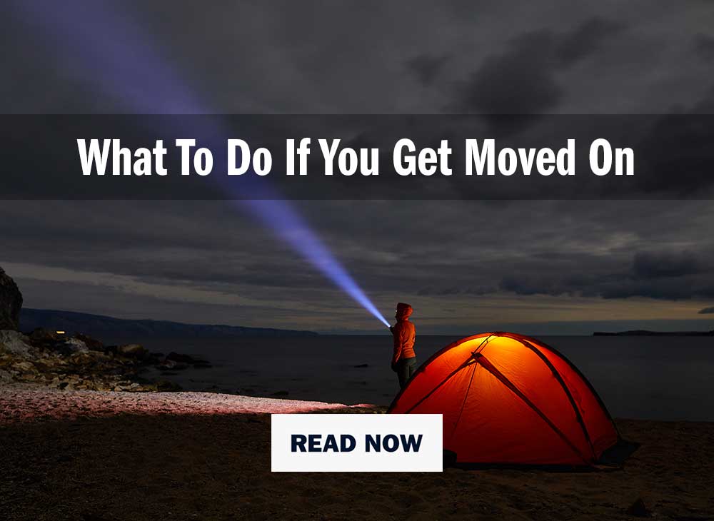 Person standing infront of a tent at night with a headtorch on